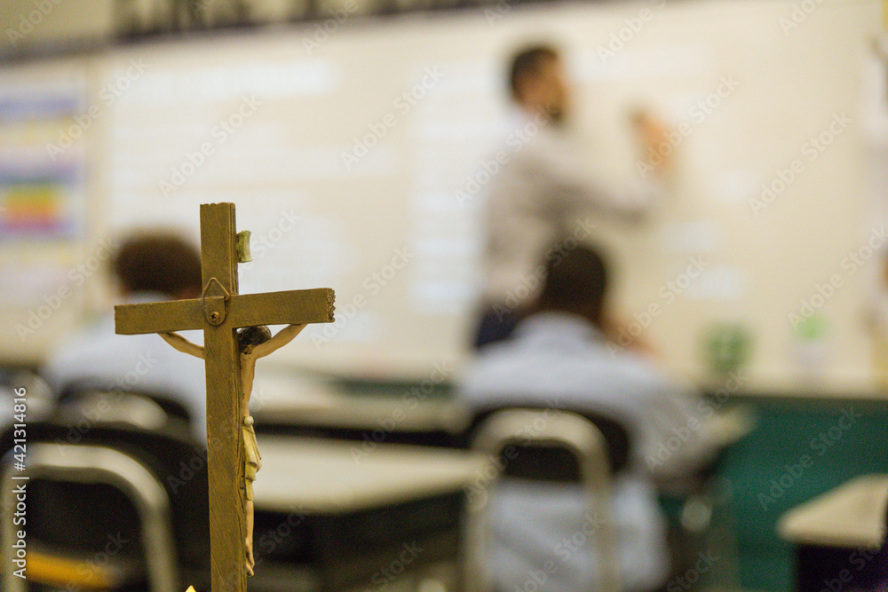 teacher in front of class during Catholic school classroom - obrazy, fototapety, plakaty 