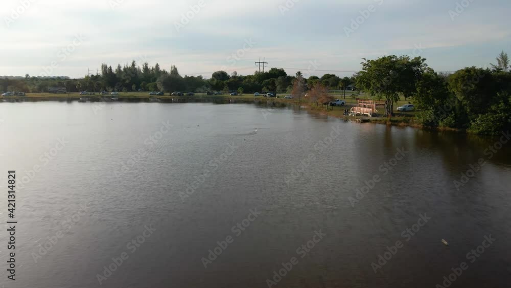 Aerial drone view towards a rc boat on a lake in Markham park, Florida Aerial drone view towards a rc boat on a lake in Markham park, Florida