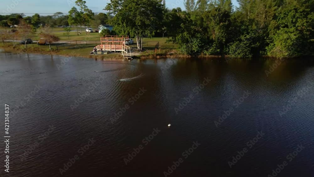 Aerial view around rc boats on a lake, sunny evening, in Florida - circling, drone shot Aerial view around rc boats on a lake, sunny evening, in Florida - circling, drone shot