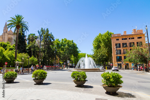 Plaza de la Reina, Boulevard Passeig del Born roundabout water fountain junction near the La Seu Cathedral and Almudaina Palace gardens in Palma Mallorca. photo