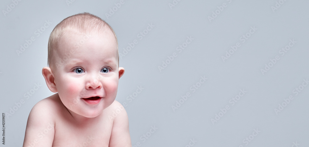Portrait of Funny toddler boy sitting on white floor in diaper with amazed happy face isolated Portrait of Funny toddler boy sitting on white floor in diaper with amazed happy face isolated
