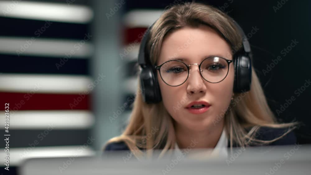 Closeup business woman headphones talking online video call. Shot with RED camera in 4K Closeup business woman headphones talking online video call. Shot with RED camera in 4K