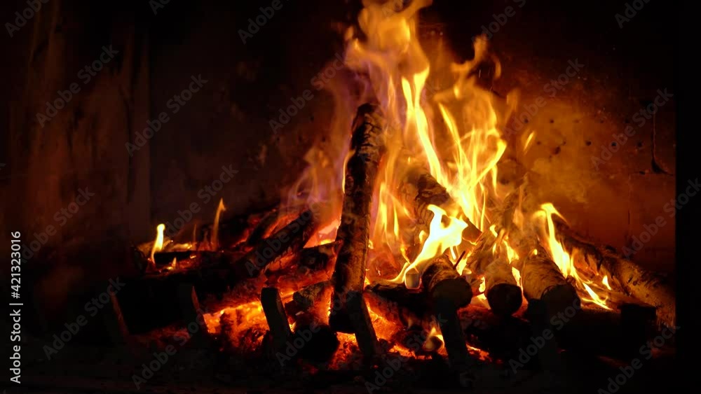 fire, burning wood in a fireplace made of brick walls, closer static front shot fire, burning wood in a fireplace made of brick walls, closer static front shot