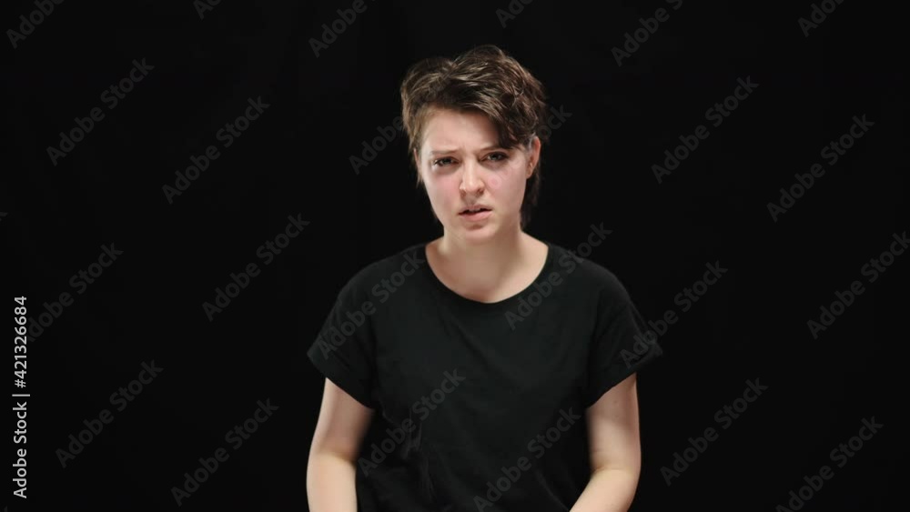 Serious young woman taking off ropes releasing from slavery or tyranny. Portrait of young Caucasian oppressed brunette lady looking at camera posing at black background. Fight for human rights. Serious young woman taking off ropes releasing from slavery or tyranny. Portrait of young Caucasian oppressed brunette lady looking at camera posing at black background. Fight for human rights.