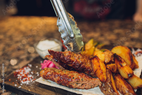 grilled seiki on a wooden board with potato sauce and vegetables. photo