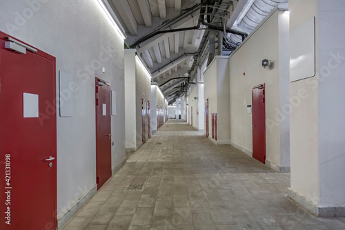 Long office corridor in modern industrial production area © ironstuffy