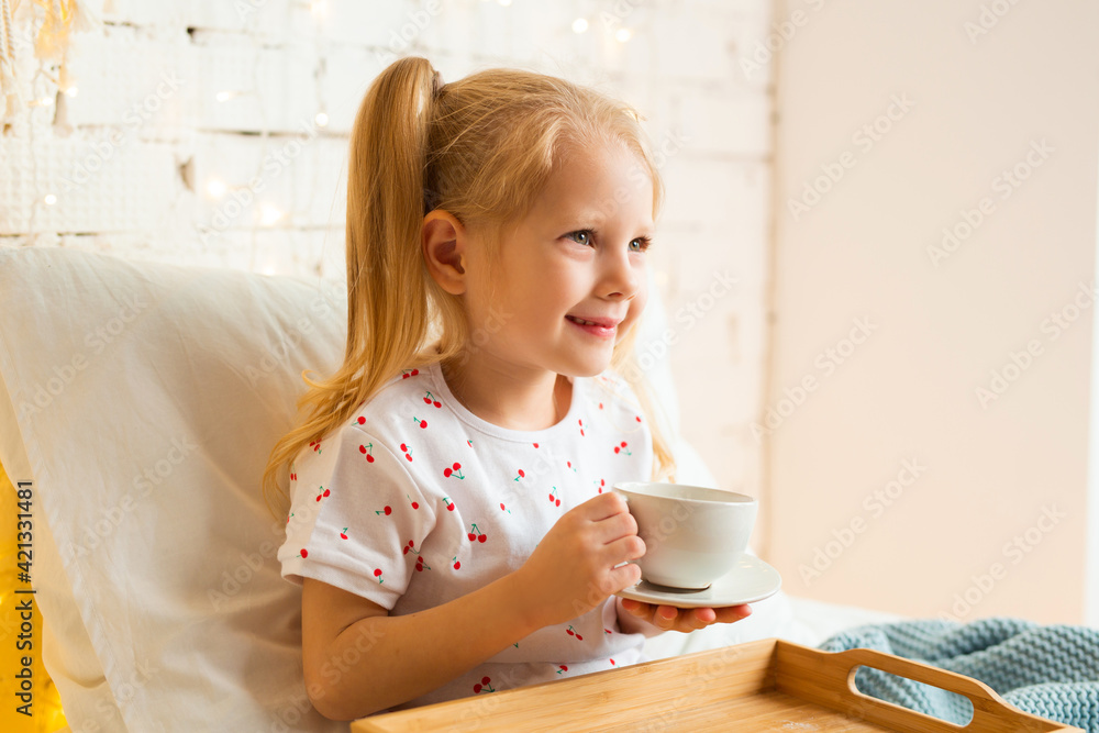 beautiful little girl sitting on the bed with a cup of tea
beautiful little girl sitting on the bed with a cup of tea
