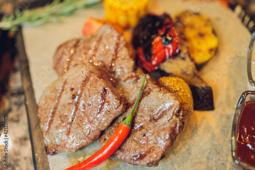 grilled seiki on a wooden board with potato sauce and vegetables. photo