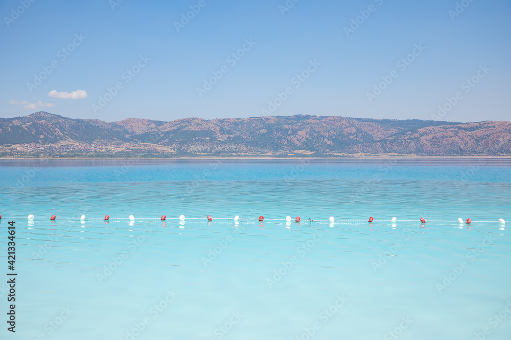 Beautiful view of white beach and blue water of Salda Lake, Burdur, Turkey