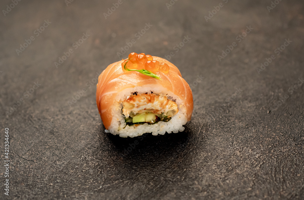 one sushi roll on a stone background one sushi roll on a stone background