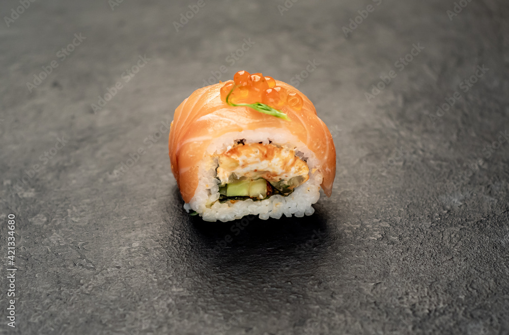 one sushi roll on a stone background one sushi roll on a stone background