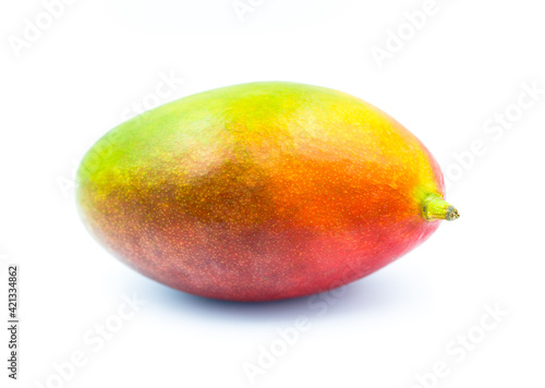 Whole mango fruit isolated on a white background. Fropical addition to slimming diets and a great natural snack.
