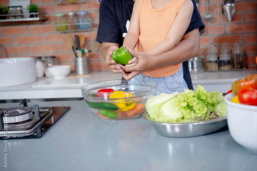Hands of family washing fresh paprika and vegetables fruit in glass bowl. Hands of family washing fresh paprika and vegetables fruit in glass bowl.