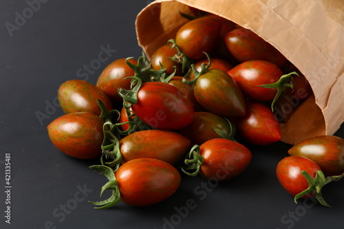 fresh cherry tomatoes on black  background.