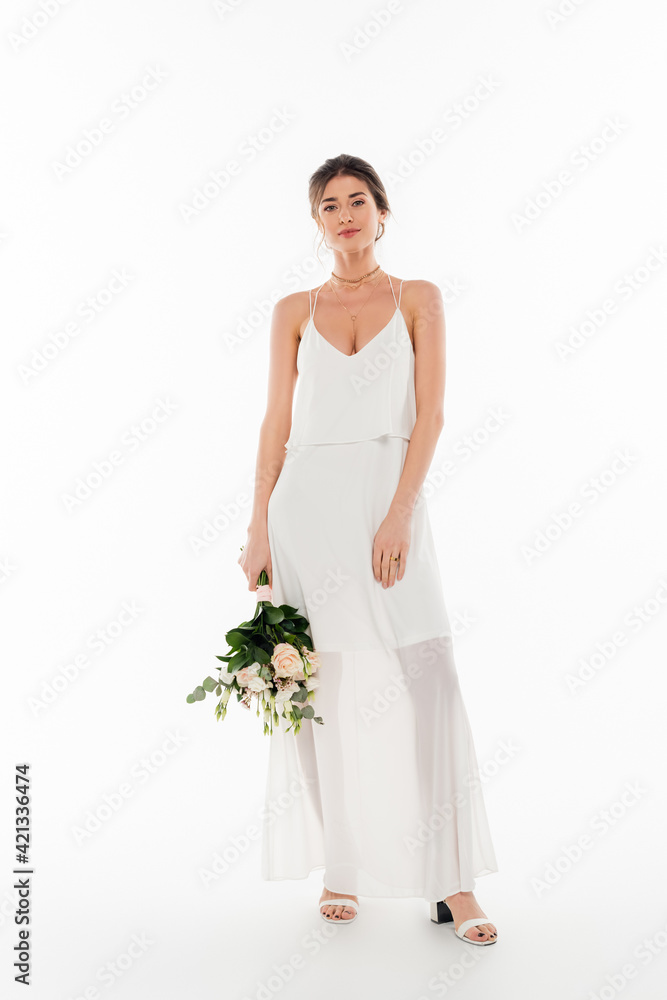 full length view of smiling bride holding wedding bouquet on white full length view of smiling bride holding wedding bouquet on white