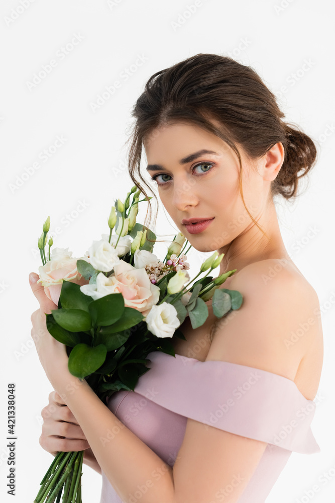 sensual, brunette woman looking at camera while holding wedding bouquet isolated on white sensual, brunette woman looking at camera while holding wedding bouquet isolated on white