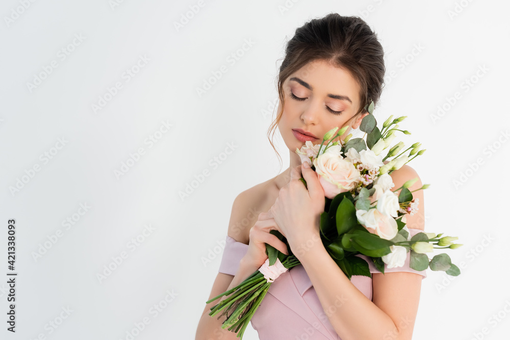 pretty woman standing with closed eyes and holding wedding bouquet isolated on grey pretty woman standing with closed eyes and holding wedding bouquet isolated on grey