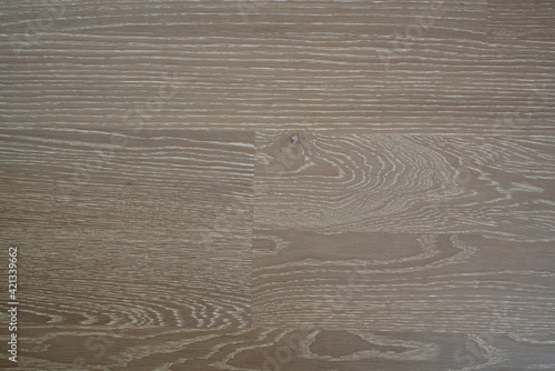 The flooring is made of natural oak with a gray tint and a white patina. Wooden parquet. Creative vintage background.