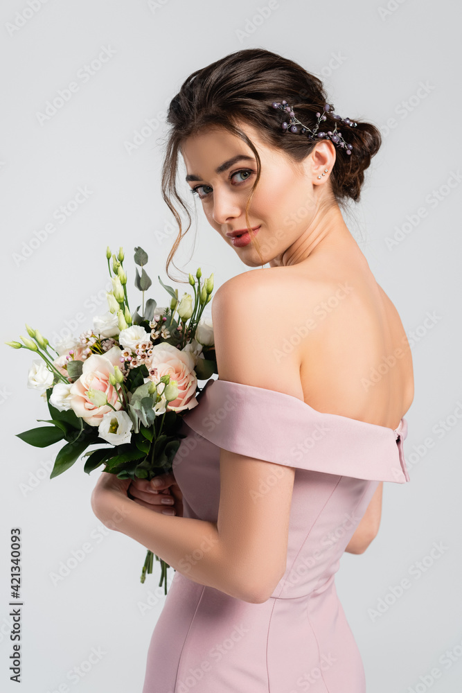 charming bride with wedding bouquet looking at camera isolated on grey charming bride with wedding bouquet looking at camera isolated on grey