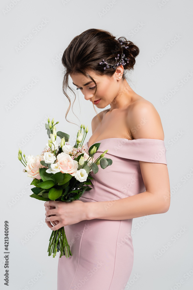 sensual bride in dress holding wedding bouquet isolated on grey sensual bride in dress holding wedding bouquet isolated on grey