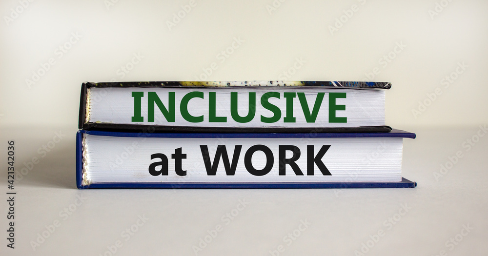 Inclusive at work symbol. Books with words 'Inclusive at work' on beautiful white background. Business, inclusive at work concept. Copy space.