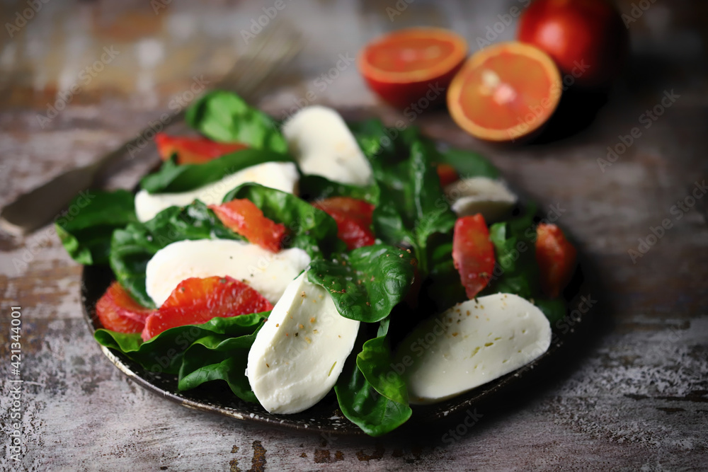 Healthy salad with spinach, mozzarella and red orange. Diet food. Fitness food.