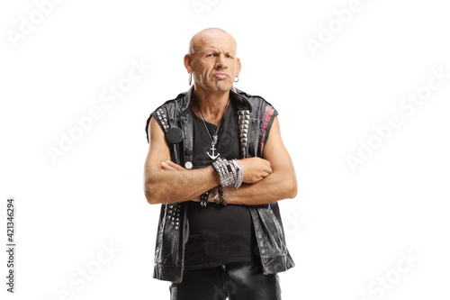 Bald punk standing with arms crossed