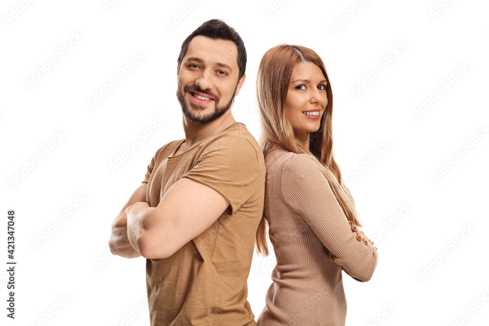 Couple posing back to back and smiling Couple posing back to back and smiling