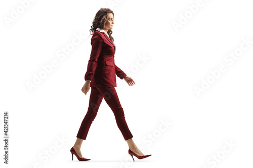 Full length profile shot of a young professional woman walking in high heels