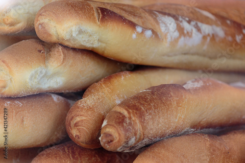 loaves of french baguette of bread oiled in a store display window photo