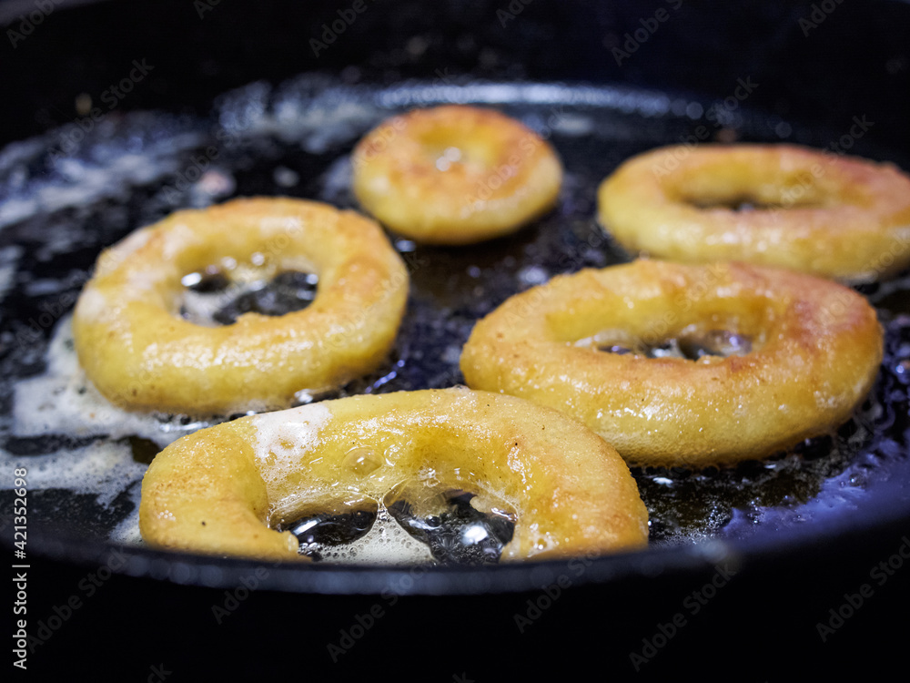 Close up overhead shot of breaded calamari rings in the frying pan Close up overhead shot of breaded calamari rings in the frying pan