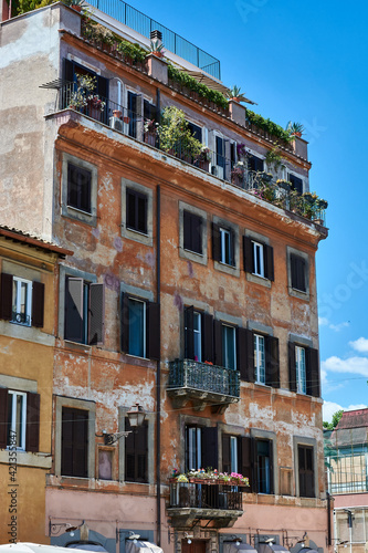 A view of facade of generic picturesque roman building with aged walls on the streets of Rome, Italy.