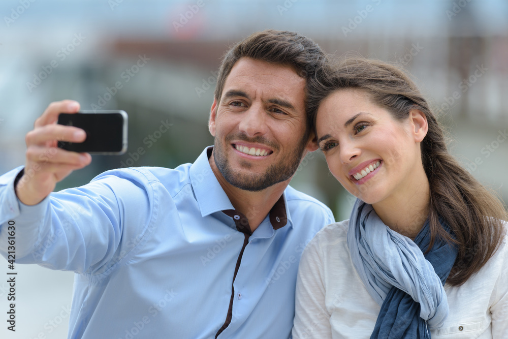 couple wearing casual clothing taking selfie couple wearing casual clothing taking selfie