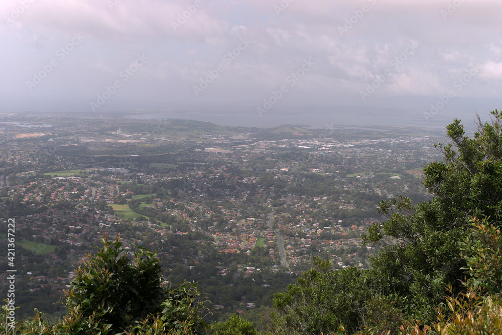 Looking down on the outer suburbs of Wollongong city on hazy day
