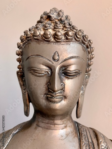 Precious antique Buddha face that reflects kindness and tranquility 
 