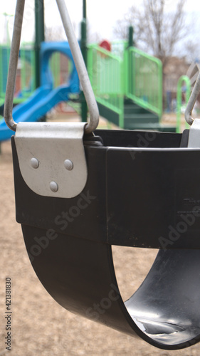 Abandoned swing in Victoria Park on a cloudy day, during the covid 19 pandemic.
