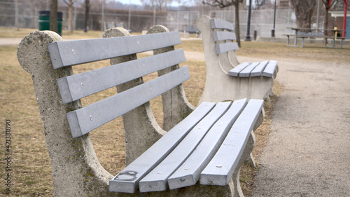 Abandoned bench in Victoria Park on a cloudy day, during the covid 19 pandemic.
