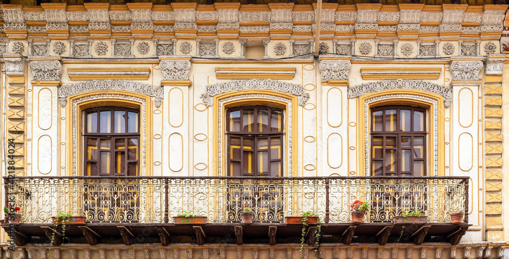 Colonial style balcony with flowers panorama, Cuenca city, Ecuador.