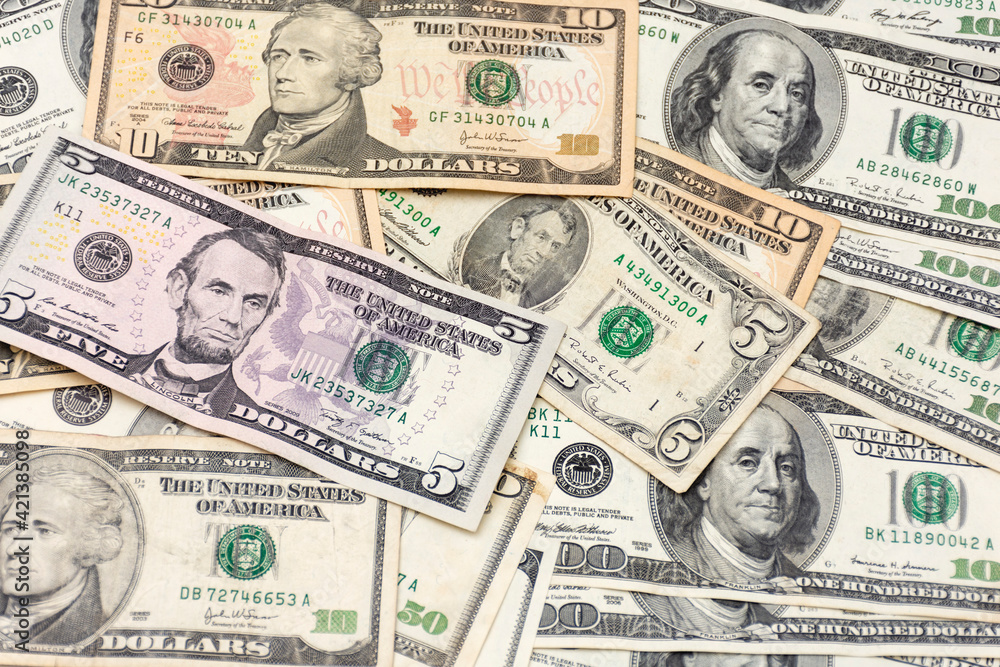 Many banknotes on a table. Dollars on the table. background with united states dollar bills. Many banknotes on a table. Dollars on the table. background with united states dollar bills.