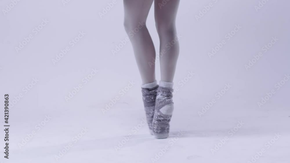 Young woman ballerina in black dress standing on pointe shoes Young woman ballerina in black dress standing on pointe shoes
