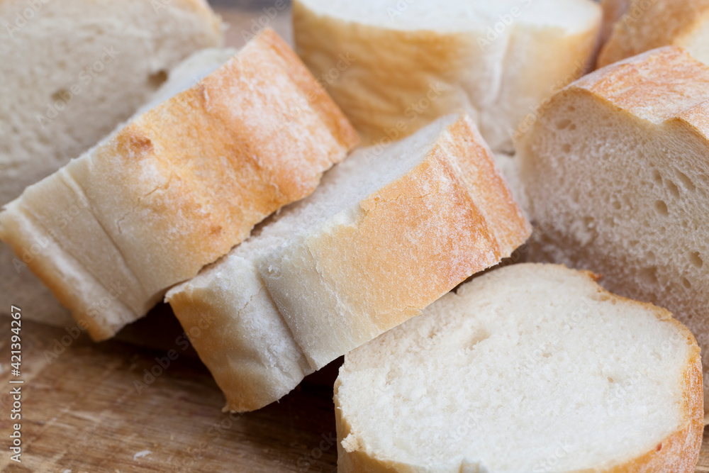 loaf of wheat baguette cut into slices loaf of wheat baguette cut into slices