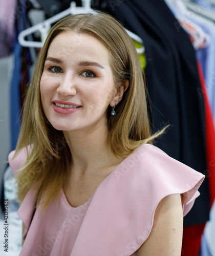 Portrait adults caucasian woman long blonde hair wearing pink dress look at camera and smile teeth do happy in dressing room