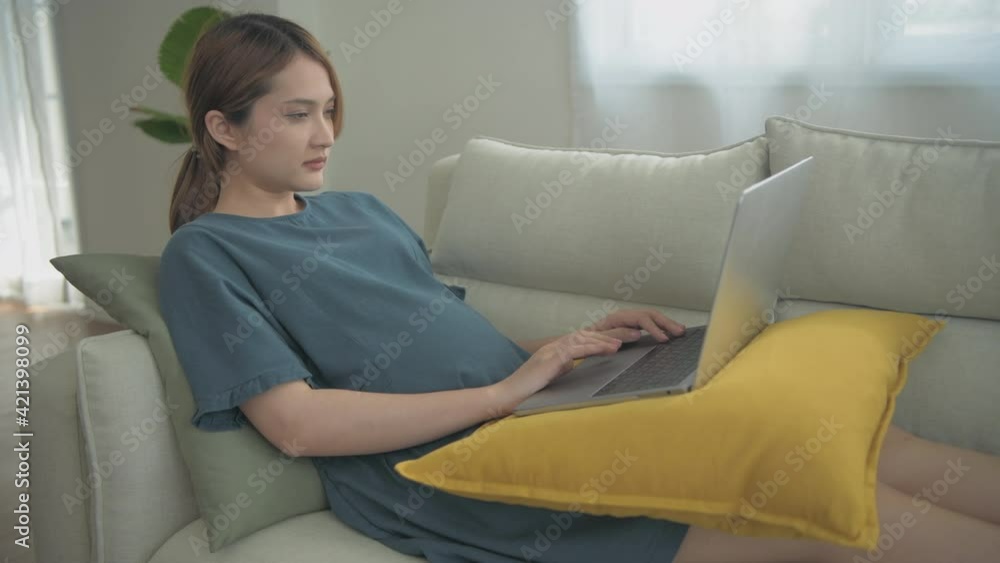 Pregnant woman concept of 4k Resolution. Asian girls are working using computers in the house. Pregnant woman concept of 4k Resolution. Asian girls are working using computers in the house.