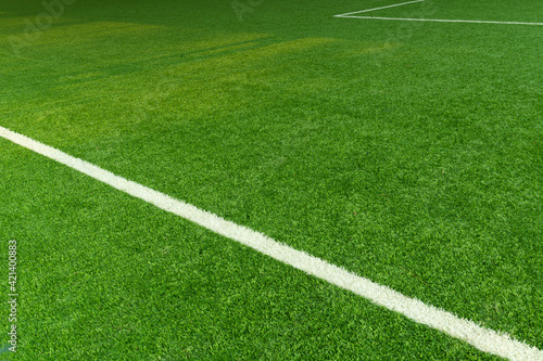 green artificial grass football field with white line