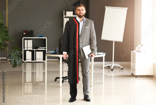 Comparison portrait of young man in bachelor robe and formal clothes in office photo