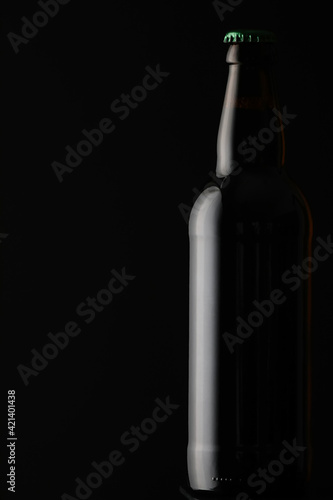 Stylish bottle on dark background