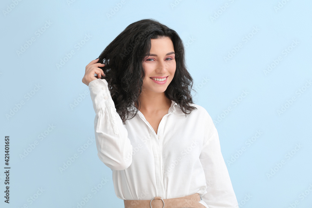 Portrait of young woman with beautiful curly hair on color background Portrait of young woman with beautiful curly hair on color background