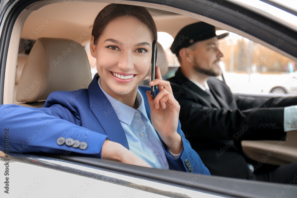 Young businesswoman talking by phone in luxury car Young businesswoman talking by phone in luxury car