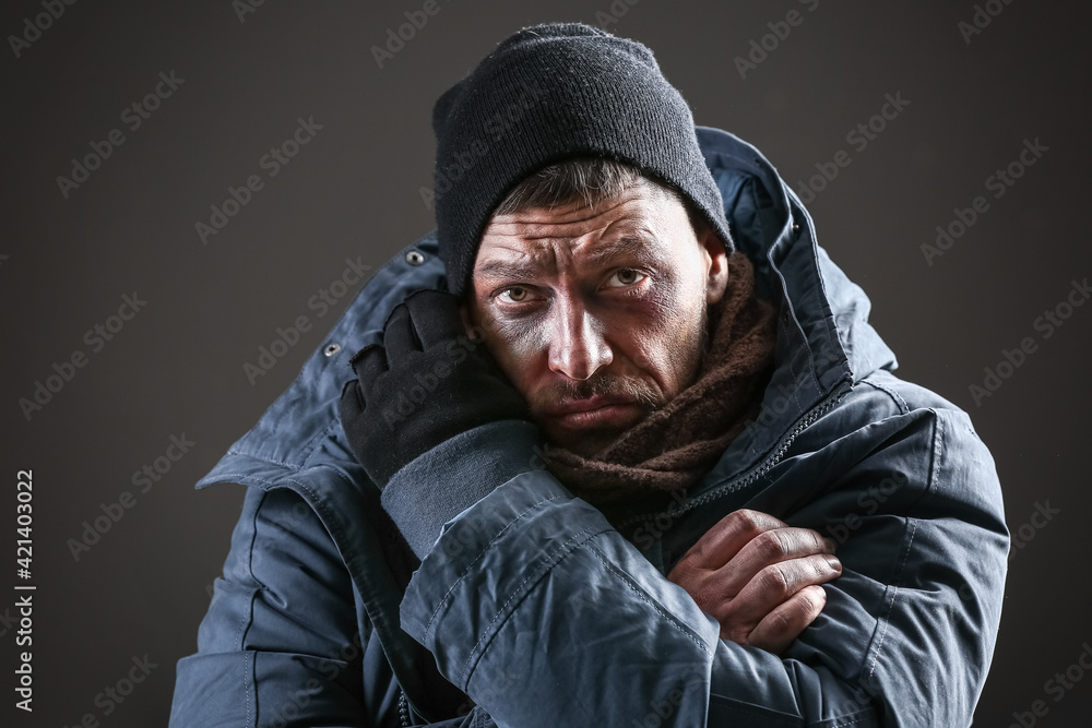 Portrait of poor homeless man on dark background