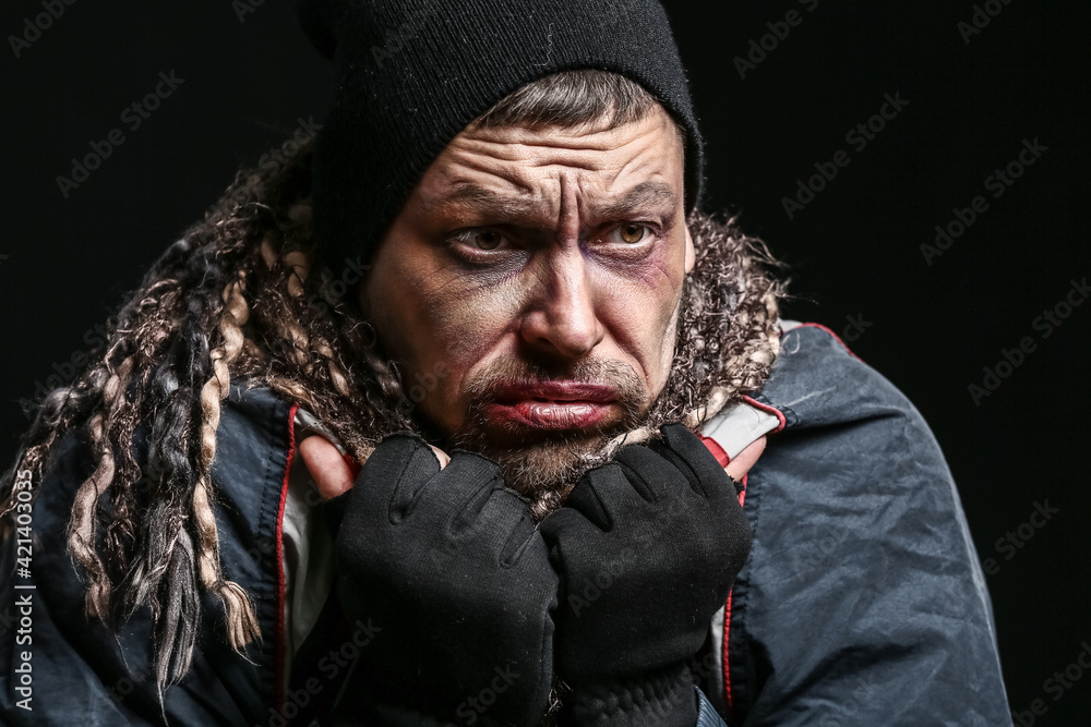 Portrait of poor homeless man on dark background Portrait of poor homeless man on dark background